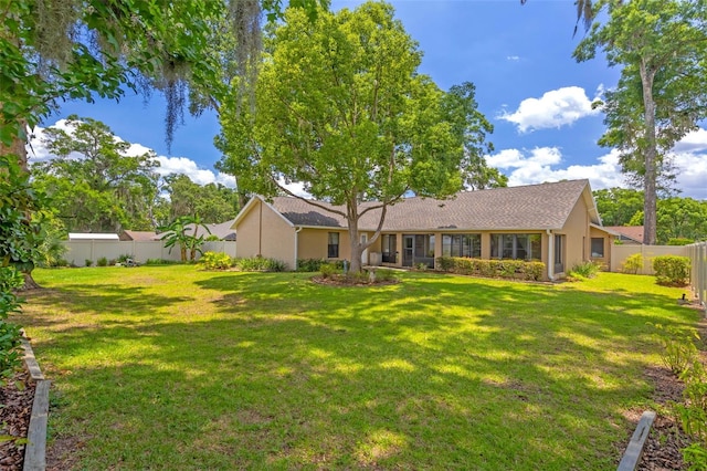 2921 SE 38th Pl, Ocala, FL 34480 - rear view of house with stucco siding and a fenced backyard