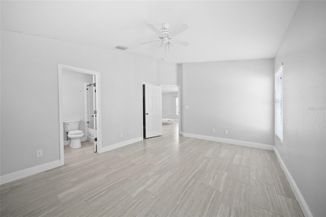 11363 Cocoa Beach Dr, Riverview, FL 33569 - unfurnished bedroom with baseboards, ensuite bath, ceiling fan, and light wood-type flooring