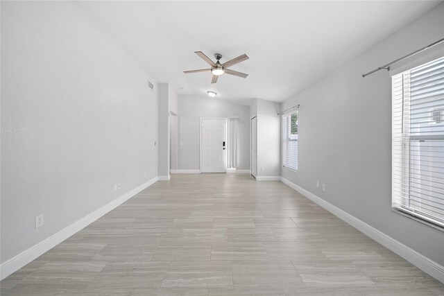 11363 Cocoa Beach Dr, Riverview, FL 33569 - spare room with a ceiling fan, lofted ceiling, and baseboards
