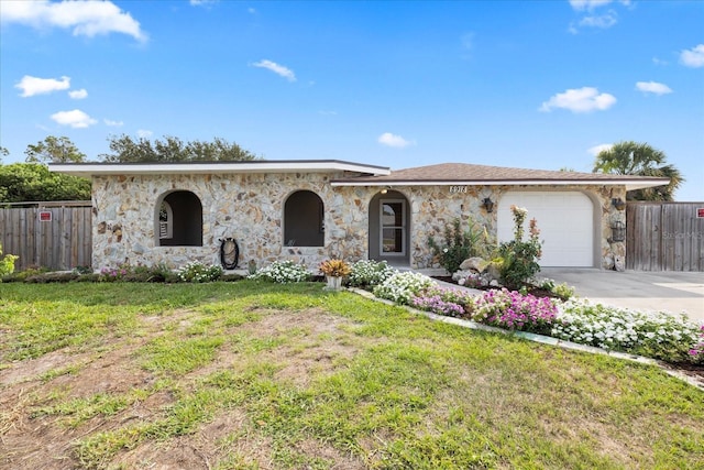 8918 Carmen Ln, Port Richey, FL 34668 - view of front of house with stone siding, an attached garage, and concrete driveway