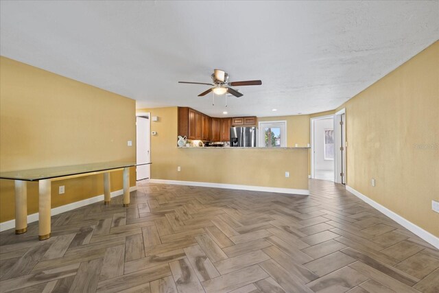 8918 Carmen Ln, Port Richey, FL 34668 - unfurnished living room with ceiling fan and baseboards