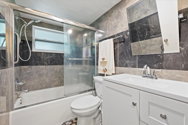 8918 Carmen Ln, Port Richey, FL 34668 - full bath featuring tile walls, toilet, vanity, enclosed tub / shower combo, and tasteful backsplash