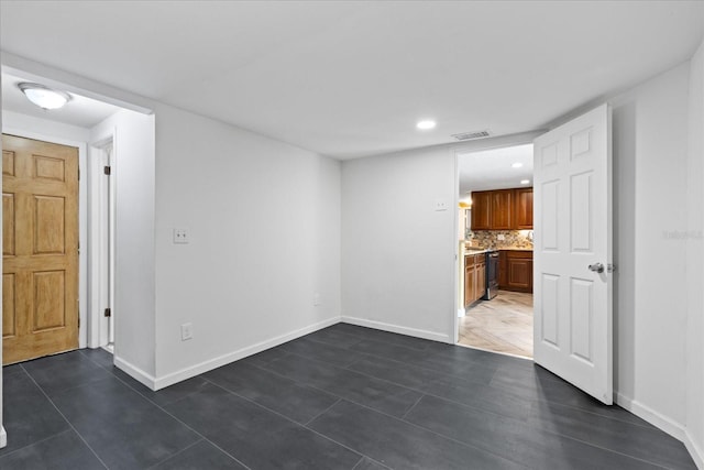 8918 Carmen Ln, Port Richey, FL 34668 - tiled empty room with baseboards and recessed lighting
