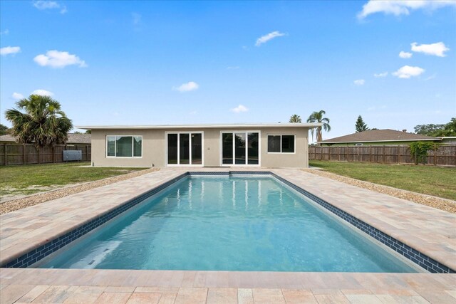 8918 Carmen Ln, Port Richey, FL 34668 - back of property with stucco siding and a patio
