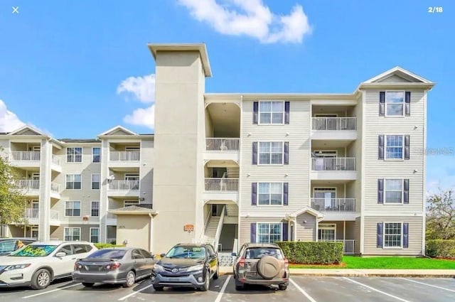3175 Feltrim Pl Unit 405, Kissimmee, FL 34747 - view of apartment building / complex with uncovered parking