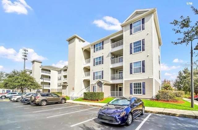 3175 Feltrim Pl Unit 405, Kissimmee, FL 34747 - view of apartment building / complex featuring uncovered parking