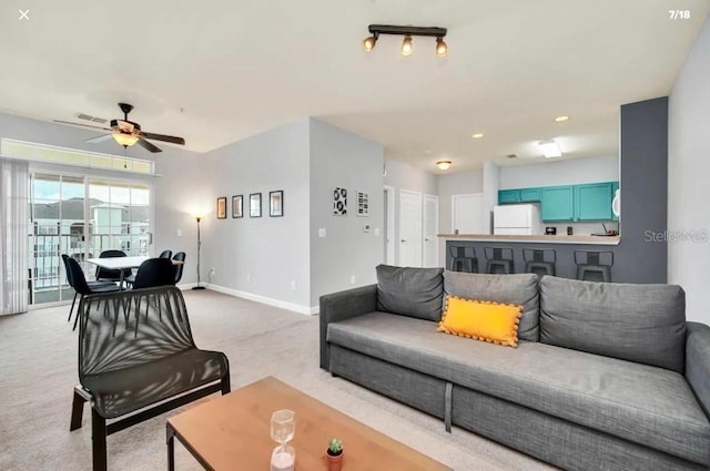 3175 Feltrim Pl Unit 405, Kissimmee, FL 34747 - living room with light carpet and ceiling fan