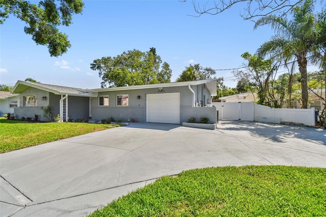 94 Nicholas Dr, Dunedin, FL 34698 - ranch-style house featuring an attached garage, a gate, driveway, and stucco siding