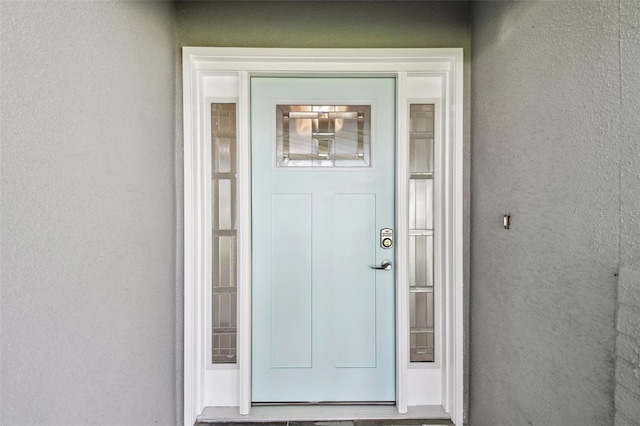 94 Nicholas Dr, Dunedin, FL 34698 - view of exterior entry featuring stucco siding