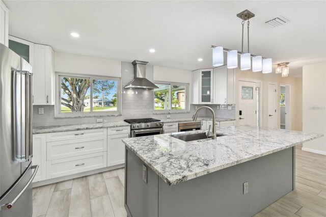 94 Nicholas Dr, Dunedin, FL 34698 - kitchen featuring wall chimney exhaust hood, stainless steel appliances, a sink, backsplash, and recessed lighting