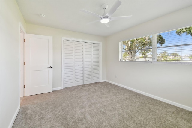 94 Nicholas Dr, Dunedin, FL 34698 - unfurnished bedroom featuring carpet flooring, a closet, and baseboards
