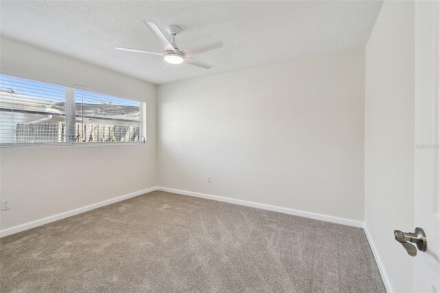 94 Nicholas Dr, Dunedin, FL 34698 - carpeted empty room featuring baseboards and a ceiling fan