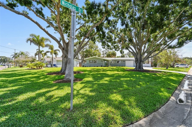 94 Nicholas Dr, Dunedin, FL 34698 - ranch-style house with a front lawn and a garage