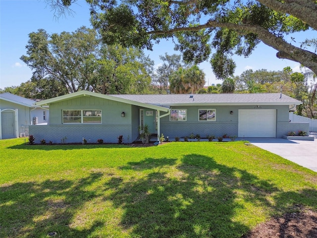 94 Nicholas Dr, Dunedin, FL 34698 - ranch-style home featuring brick siding, a garage, a front lawn, and driveway