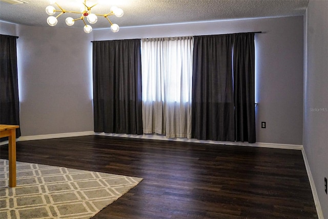 1204 Rinkfield Pl, Brandon, FL 33511 - unfurnished room featuring baseboards, a chandelier, wood finished floors, and a textured ceiling