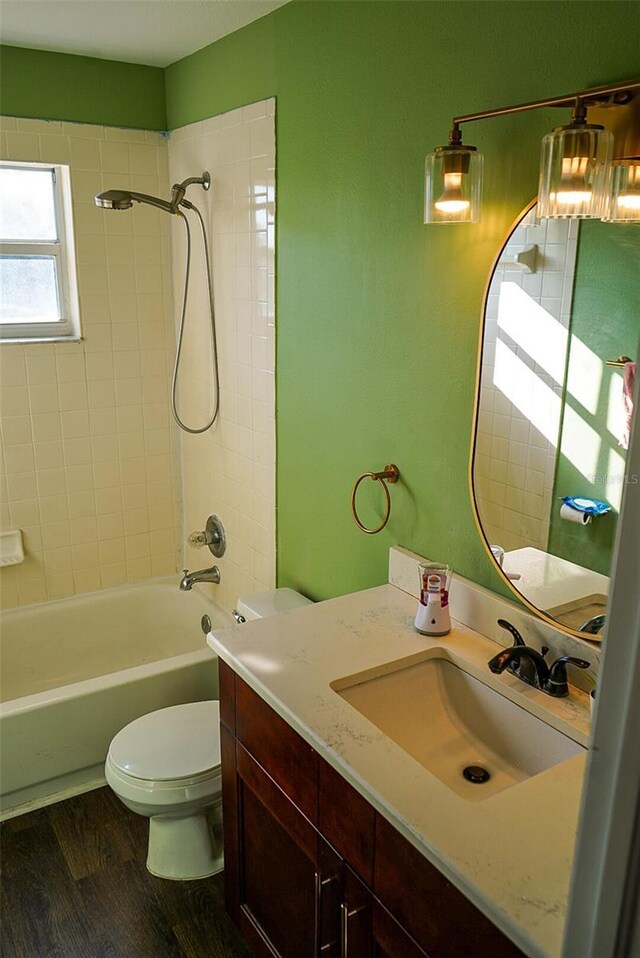 1204 Rinkfield Pl, Brandon, FL 33511 - bathroom with toilet, vanity, wood finished floors, and shower / washtub combination