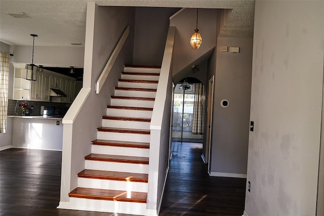 1204 Rinkfield Pl, Brandon, FL 33511 - staircase with a textured ceiling, wood finished floors, and baseboards