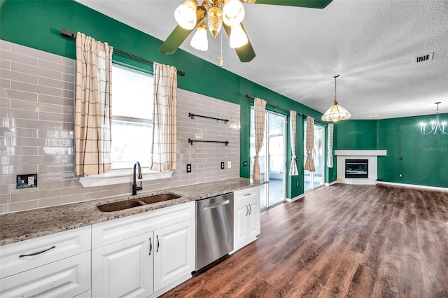 1204 Rinkfield Pl, Brandon, FL 33511 - kitchen with dishwasher, a textured ceiling, decorative backsplash, and plenty of natural light