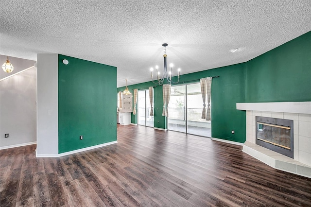 1204 Rinkfield Pl, Brandon, FL 33511 - unfurnished living room with a textured ceiling, a fireplace, wood finished floors, and a chandelier
