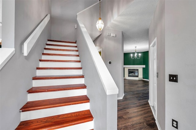 1204 Rinkfield Pl, Brandon, FL 33511 - stairway with wood finished floors, a chandelier, and a textured ceiling