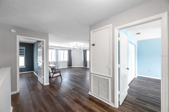 1204 Rinkfield Pl, Brandon, FL 33511 - hall featuring dark wood-type flooring, a textured ceiling, and a chandelier