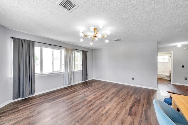 1204 Rinkfield Pl, Brandon, FL 33511 - unfurnished living room with a chandelier, dark wood-style flooring, and a textured ceiling