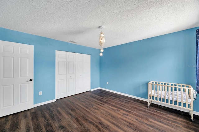 1204 Rinkfield Pl, Brandon, FL 33511 - unfurnished bedroom with wood finished floors, a closet, and a textured ceiling