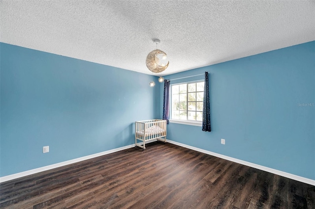 1204 Rinkfield Pl, Brandon, FL 33511 - empty room featuring dark wood-type flooring, a textured ceiling, and radiator