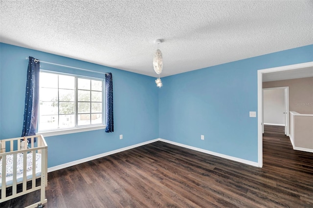 1204 Rinkfield Pl, Brandon, FL 33511 - unfurnished bedroom with dark wood-style floors and a textured ceiling