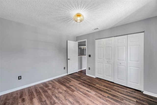 1204 Rinkfield Pl, Brandon, FL 33511 - unfurnished bedroom with wood finished floors, a closet, and a textured ceiling