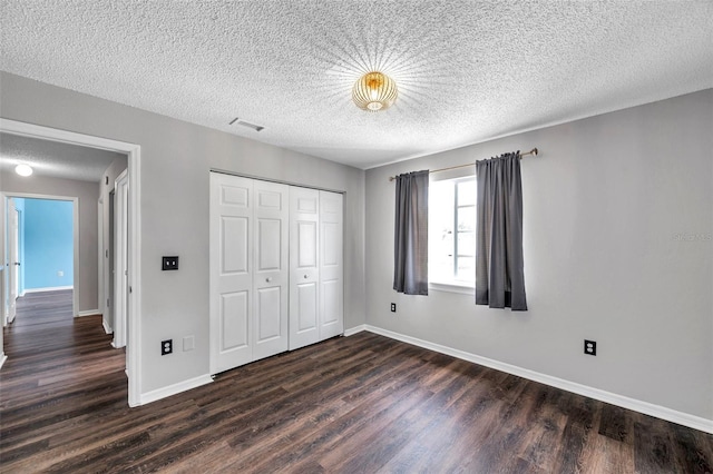 1204 Rinkfield Pl, Brandon, FL 33511 - unfurnished bedroom with dark wood-style floors, a closet, and a textured ceiling
