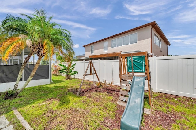 1204 Rinkfield Pl, Brandon, FL 33511 - fenced backyard featuring a sunroom and a playground