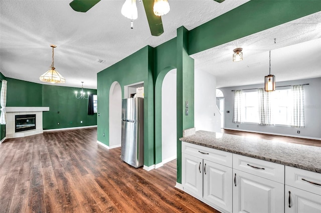 1204 Rinkfield Pl, Brandon, FL 33511 - kitchen featuring freestanding refrigerator, a textured ceiling, dark wood-style flooring, white cabinets, and open floor plan