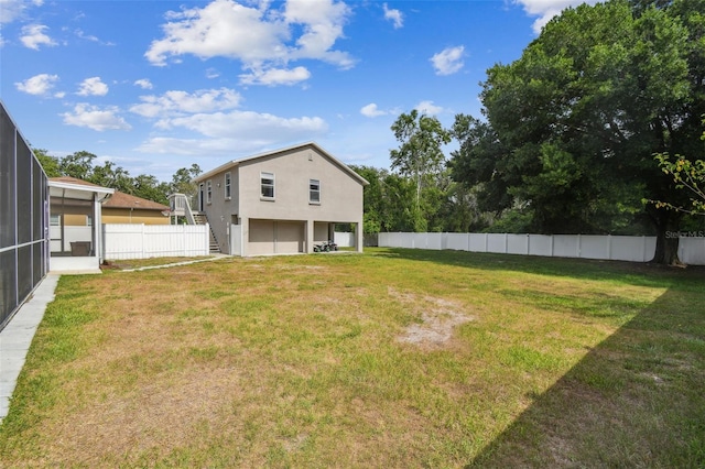 205 W 122nd Ave, Tampa, FL 33612 - rear view of house with stucco siding and a sunroom