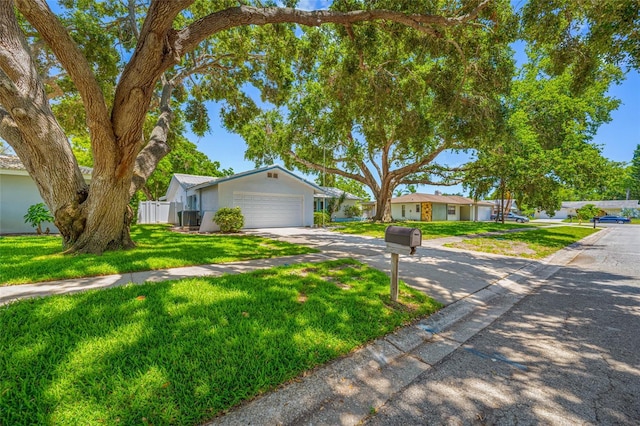 1211 Stony Brook Ln, Dunedin, FL 34698 - ranch-style house with concrete driveway, an attached garage, and stucco siding