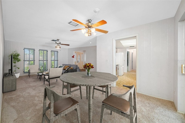 1211 Stony Brook Ln, Dunedin, FL 34698 - dining area featuring light colored carpet, a ceiling fan, and baseboards