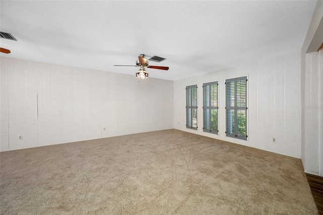 1211 Stony Brook Ln, Dunedin, FL 34698 - unfurnished room featuring ceiling fan, carpet flooring, and wooden walls