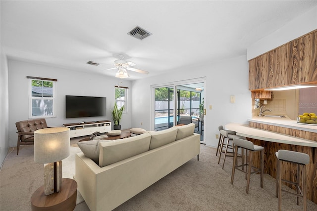 1211 Stony Brook Ln, Dunedin, FL 34698 - living room with light colored carpet and a ceiling fan