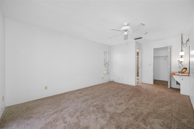 1211 Stony Brook Ln, Dunedin, FL 34698 - unfurnished bedroom featuring carpet, a spacious closet, ceiling fan, and a closet