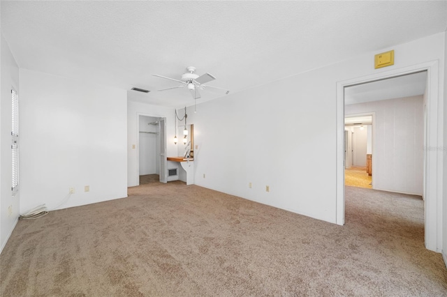 1211 Stony Brook Ln, Dunedin, FL 34698 - unfurnished bedroom with carpet, a ceiling fan, and a walk in closet