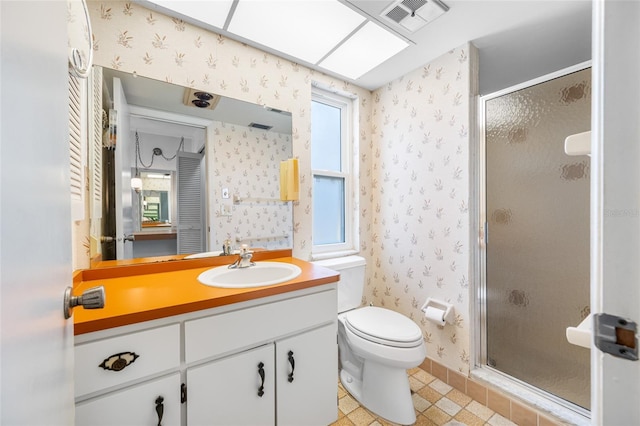 1211 Stony Brook Ln, Dunedin, FL 34698 - full bathroom featuring wallpapered walls, a shower stall, vanity, toilet, and tile patterned flooring