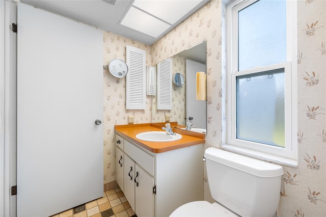 1211 Stony Brook Ln, Dunedin, FL 34698 - half bath with vanity, wallpapered walls, toilet, and tile patterned floors