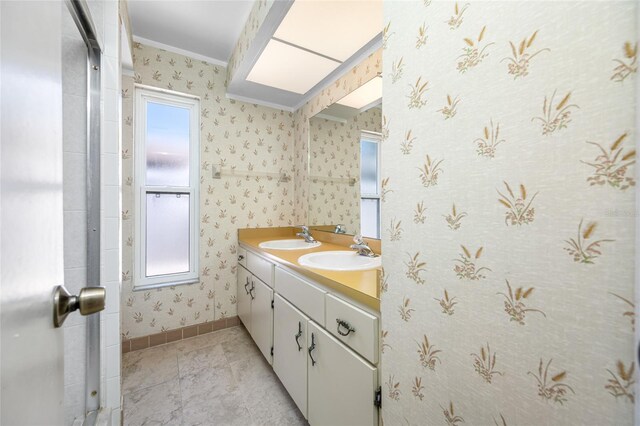 1211 Stony Brook Ln, Dunedin, FL 34698 - bathroom with ornamental molding, double vanity, healthy amount of natural light, wallpapered walls, and baseboards