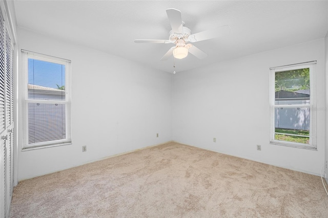 1211 Stony Brook Ln, Dunedin, FL 34698 - unfurnished room with carpet floors, healthy amount of natural light, and a ceiling fan