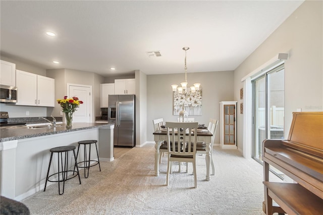 6180 Spring Crayfish Ave, New Port Richey, FL 34653 - dining area featuring light carpet, a chandelier, recessed lighting, and baseboards