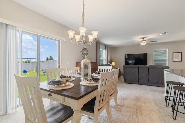 6180 Spring Crayfish Ave, New Port Richey, FL 34653 - dining area with light carpet, a chandelier, and ceiling fan