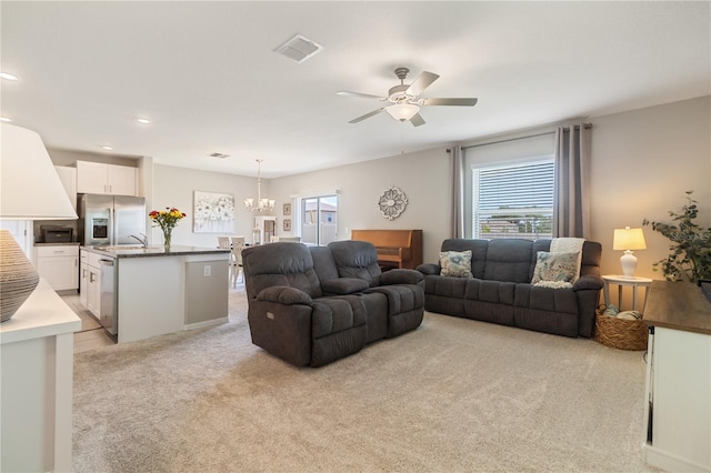 6180 Spring Crayfish Ave, New Port Richey, FL 34653 - living area featuring light colored carpet, healthy amount of natural light, a chandelier, a ceiling fan, and recessed lighting