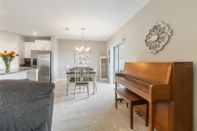 6180 Spring Crayfish Ave, New Port Richey, FL 34653 - dining room featuring a chandelier, light carpet, and baseboards