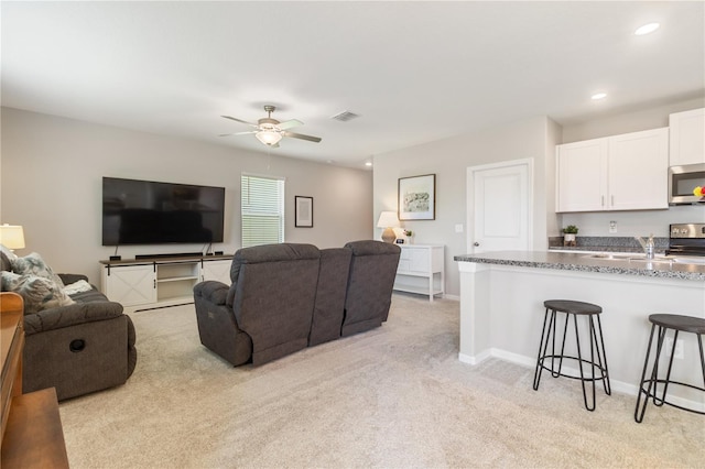 6180 Spring Crayfish Ave, New Port Richey, FL 34653 - living area featuring light colored carpet, a ceiling fan, baseboards, and recessed lighting