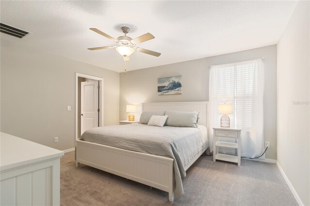 6180 Spring Crayfish Ave, New Port Richey, FL 34653 - bedroom with light carpet, baseboards, and a ceiling fan